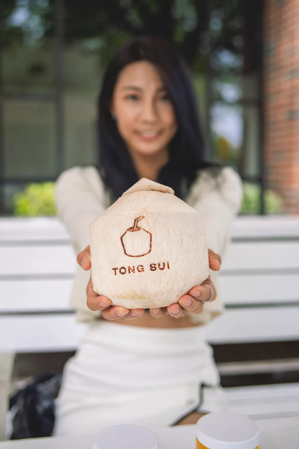 Woman holding a Tong Sui coconut