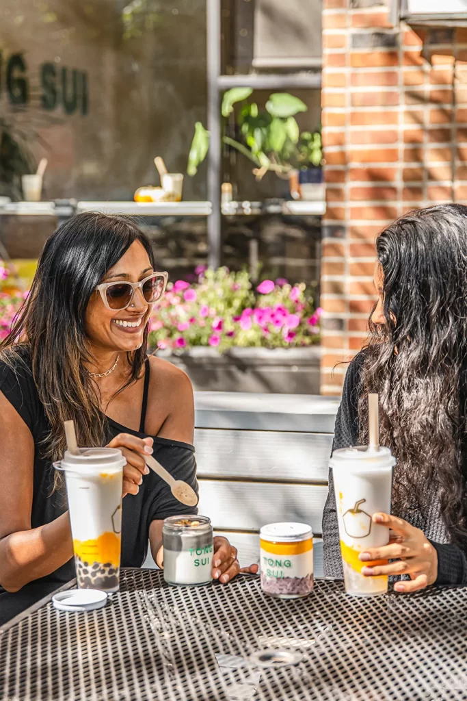 Two women enjoying Tong Sui products